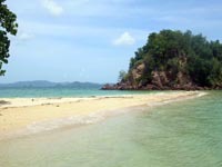 at Koh Pak Bia a thin finger of sand stretches from the island to a rock formation in the sea